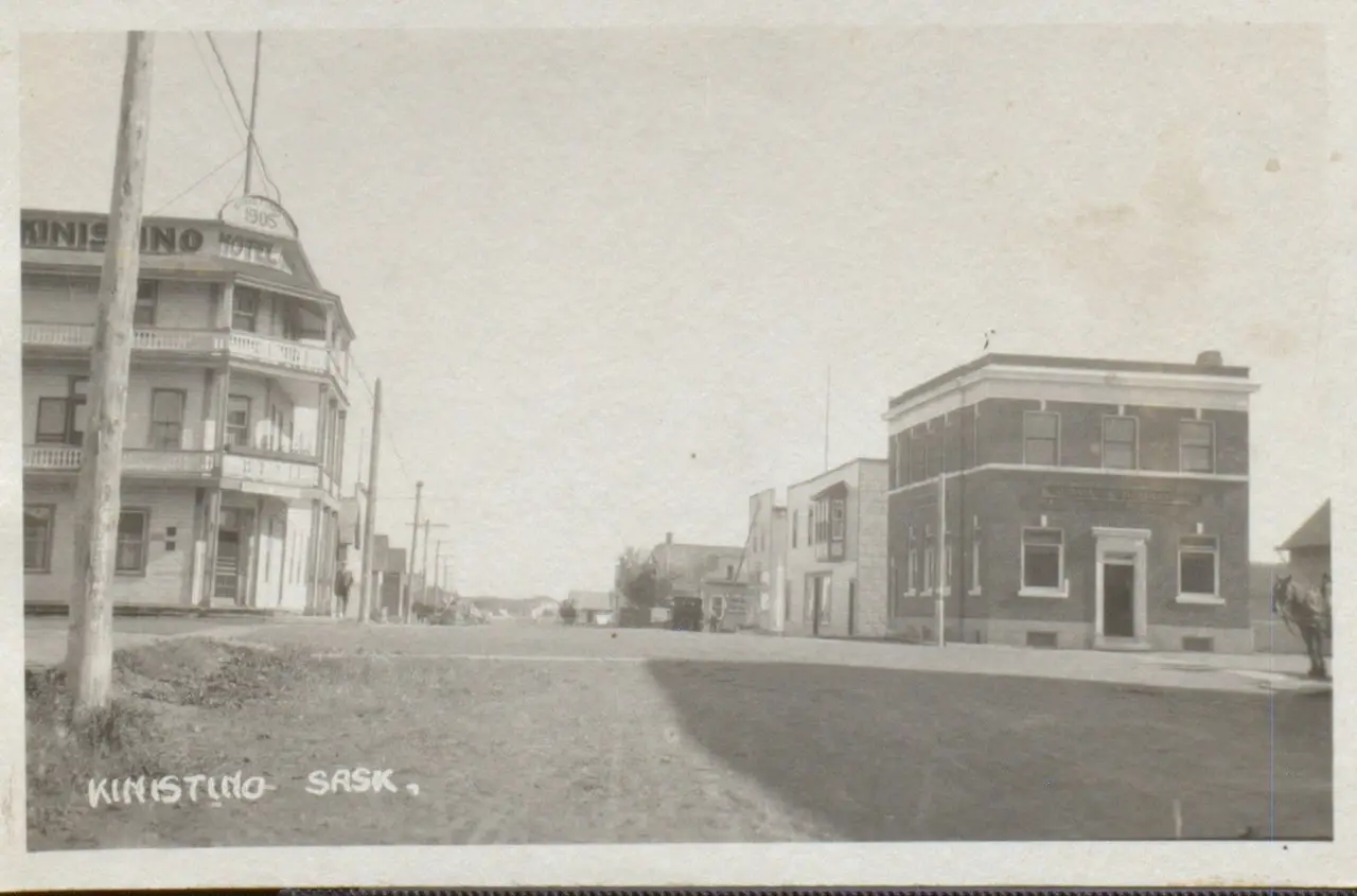 Street view with Kinistino Hotel and brick bank building, about 1910s